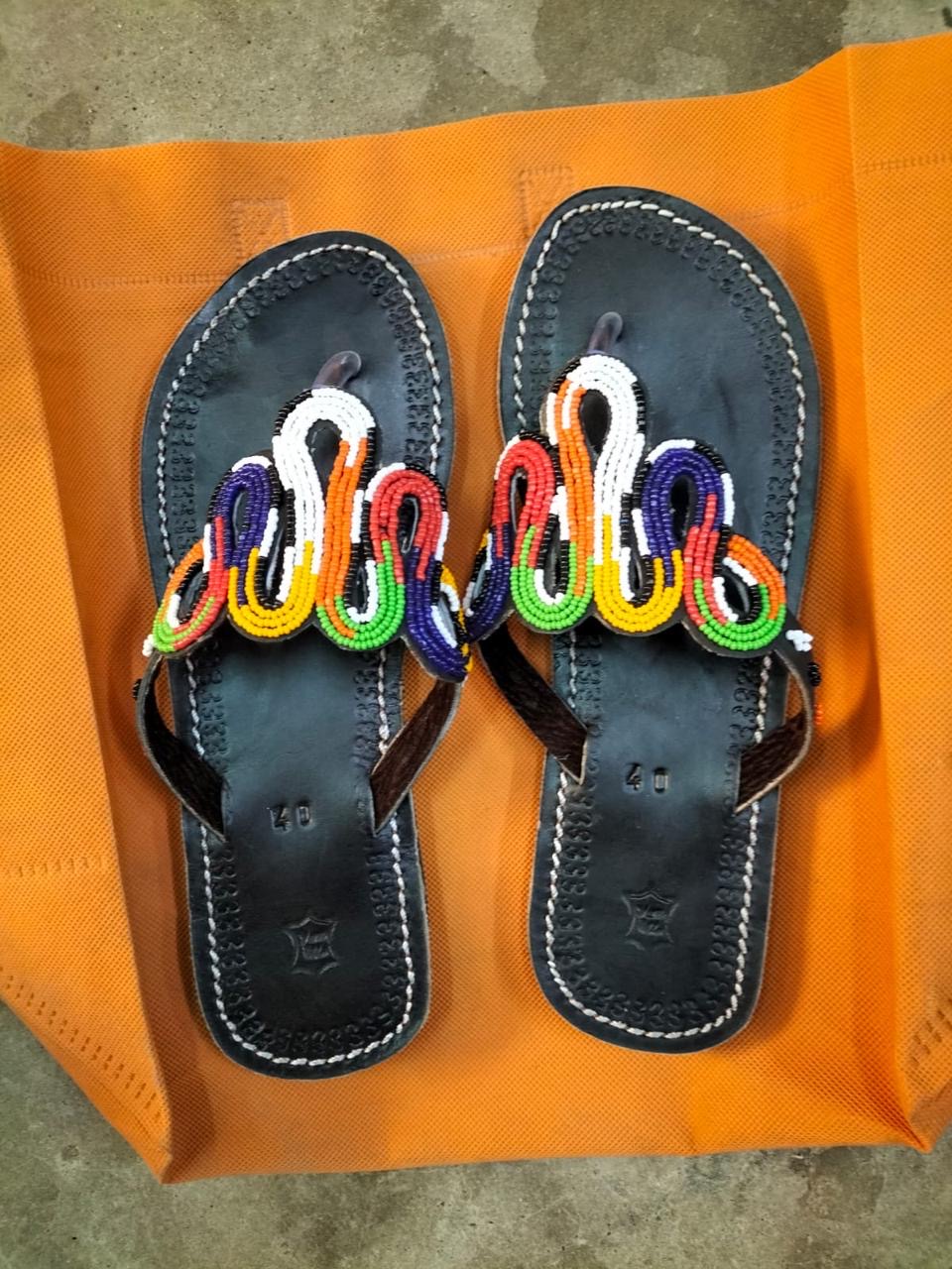 Multicolour Looped Beadwork Leather Sandals — Hand-stitched black leather thong sandals crowned with looping ribbons of red, white, indigo, green and gold glass beadwork.