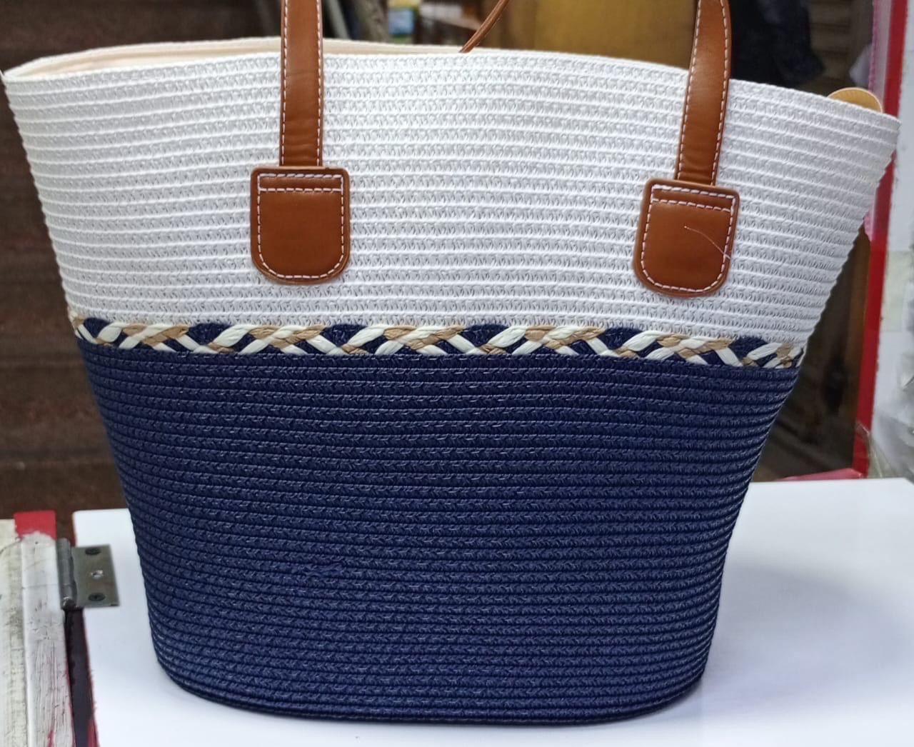 Navy and Ivory Braided-Trim Tote — A two-tone woven tote in deep navy and ivory, split by a hand-braided straw trim at the waist.