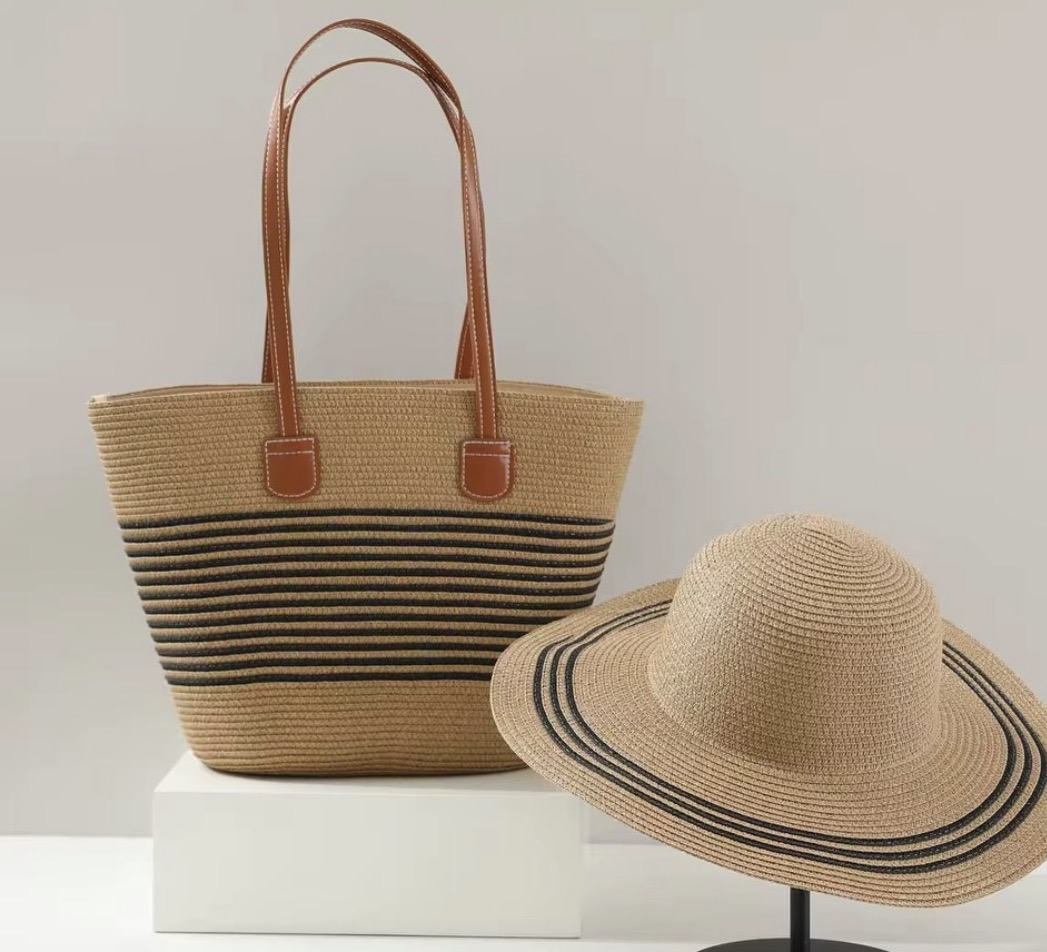 Natural and Black Striped Tote & Hat Set — A woven tote banded in black stripes with tan handles, paired with a matching wide-brim sun hat.
