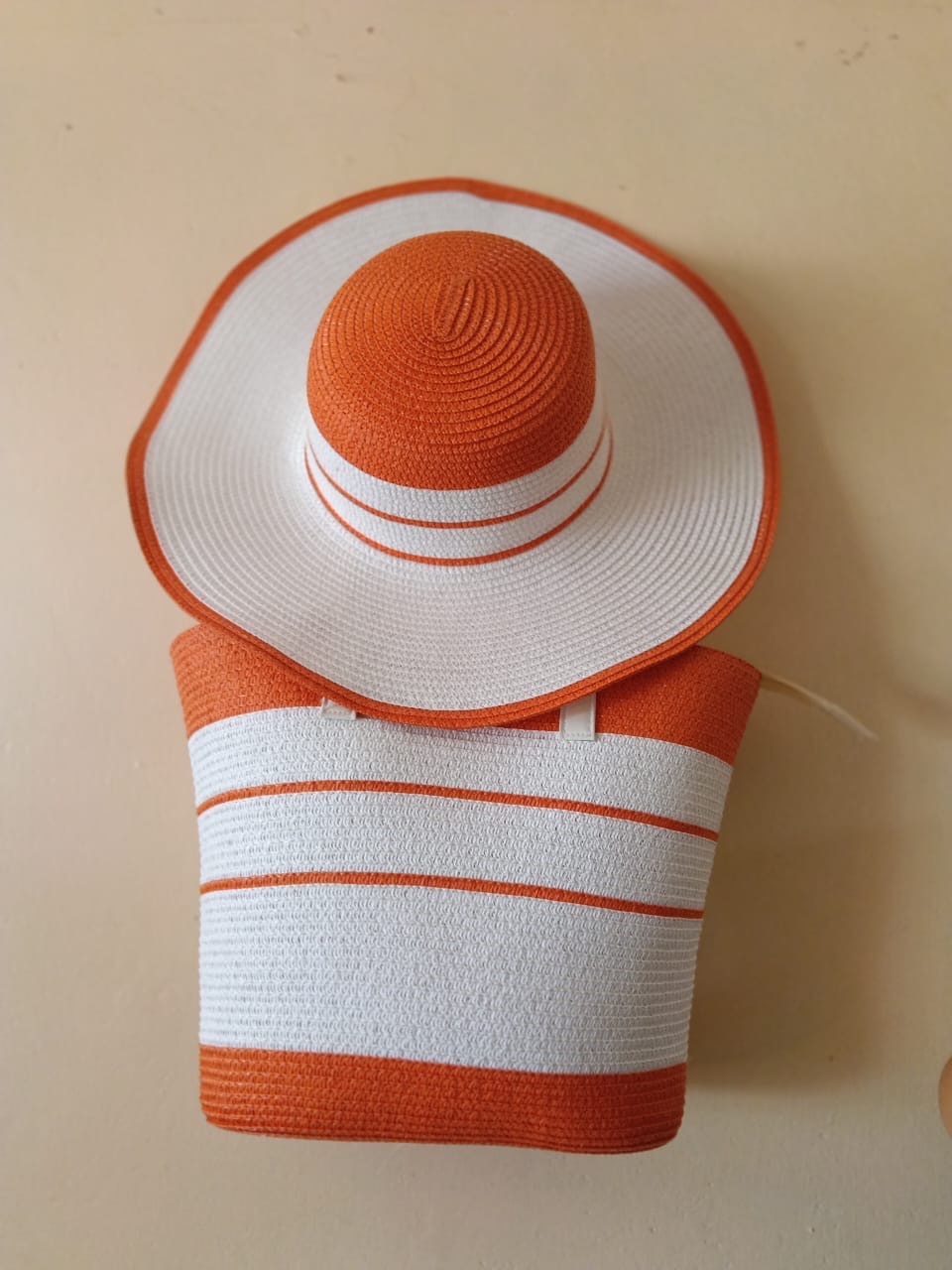 Orange and White Wide-Brim Hat & Tote Set — A coordinated orange and white wide-brim sun hat and striped tote for a bright, graphic finish.