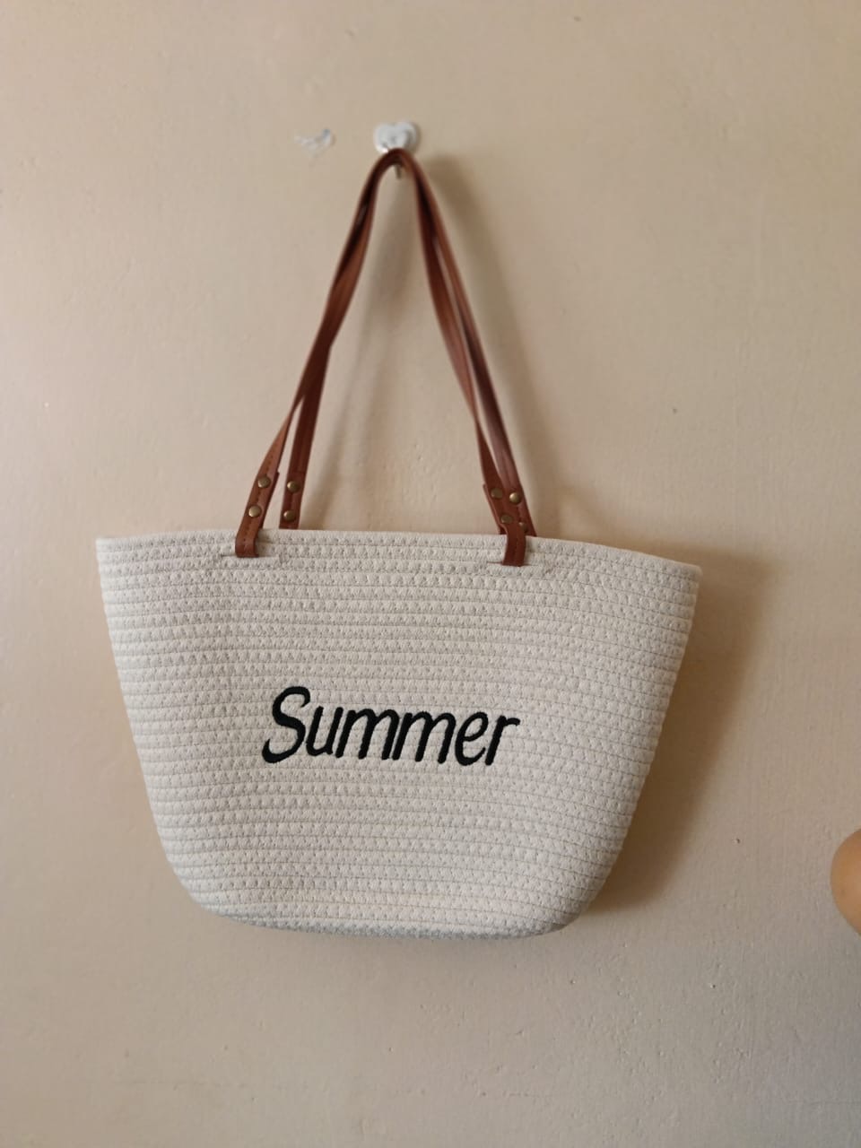 Summer Ivory Tote — A roomy ivory woven tote with brown handles and a simple black embroidered Summer motif.
